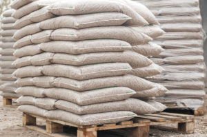 Pile of sacks of pellets, which are stacked on pallets